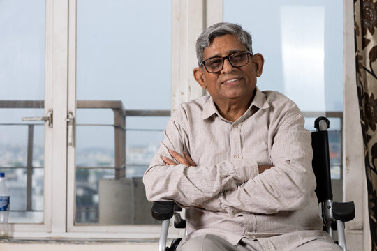 India happy disabled senior old man spending quality time at home