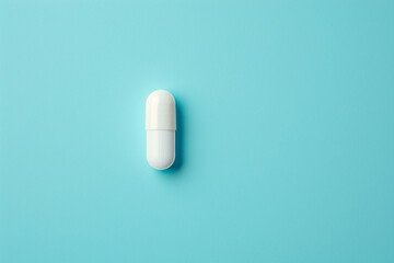 White capsule tablet on blue background 