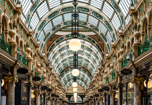 Interior view of County Arcade, a richly decorated Victorian shopping arcade with glass domes, pink marble columns and luxury stores in Leeds city centre, England, United Kingdom.
