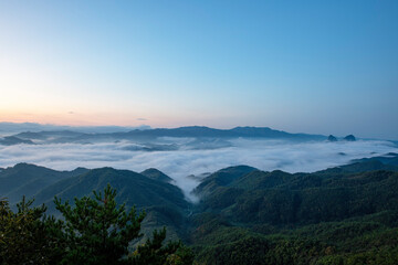 A mountaintop view in Korea with clouds settled in the valley, captured at dawn