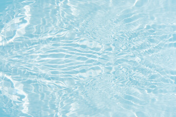 Blue water with ripples on the surface. Defocus blurred transparent blue colored clear calm water...