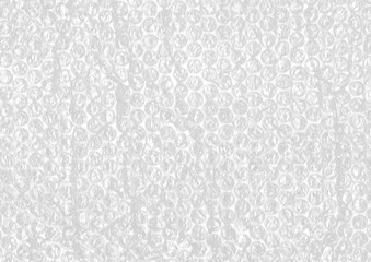 Textured bubble plastic wrap surface with gritty, tactile feel. Perfect for background textures, retro packaging effects, or recycled material aesthetics.