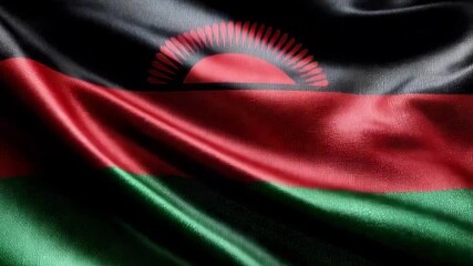 The vibrant silk flag of Malawi honors Independence Day, showcasing red, black, and green colors as it flutters gracefully.