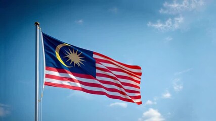 The Malaysian flag waves proudly against a bright blue sky, symbolizing national pride on Independence Day celebrations.