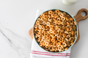 A bowl of round crispy cereal with milk. Healthy breakfast.