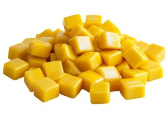 Pile of yellow candy cubes is isolated on transparent backdrop.