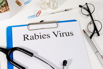 A Paper with “Rabies Virus” Title in Clipboard Set on the Desk with Stethoscope – Viral...