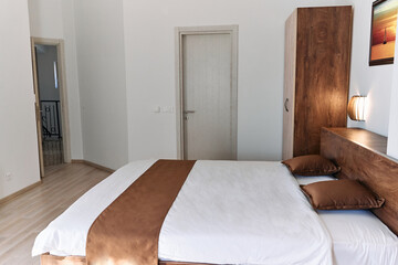 Minimalist bedroom with wooden elements and white walls