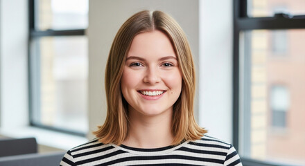 A smiling young caucasian woman with blonde hair, looking confidently at the camera