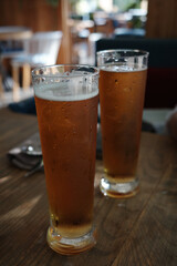 Glasses of light beer with at bar.