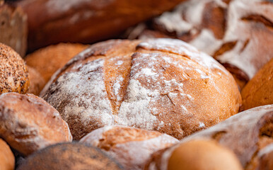 Freshly baked natural bread is on the kitchen table.