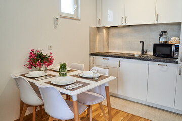 Modern kitchen interior with dining table and minimalist design features