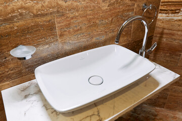 Modern ceramic sink with marble vanity and chrome faucet in stylish bathroom