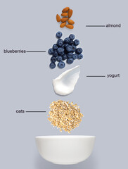 Creative concept still life health diet food photo of bowl dish with healthy breakfast oatmeal corn flackes fruits berries on grey background.