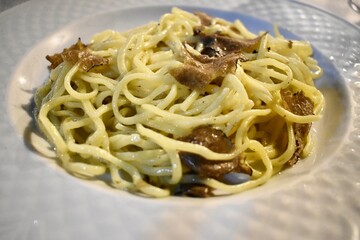 Traditional tagliolini pasta dish with truffle  from Italy Maremma area