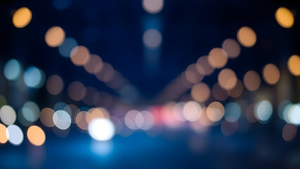 Blurred lights on a dark blue background creating an abstract bokeh effect at night time