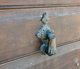 Bronze door knob in shape of a hand