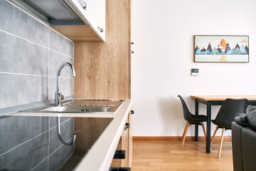 Modern kitchen and dining area with wood accents and mountain artwork