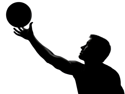 Silhouette of a Basketball Player: Dramatic, high-contrast silhouette captures a basketball player mid-action, perfectly balancing the ball above his outstretched hand.