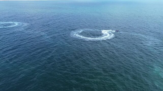Aerial view of surfing boat with tourists having fun from the top , video made by drone