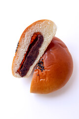 Sweet red bean bread cut in half. Soft bread and sweet red bean cream.
