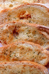 Crispy baked garlic bread. Bread seasoned with garlic and herbs.