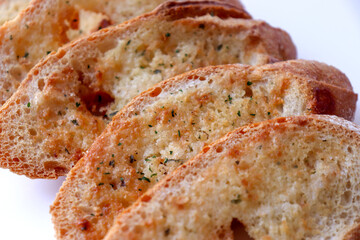 Crispy baked garlic bread. Bread seasoned with garlic and herbs.