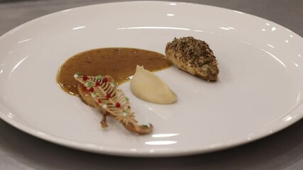 A beautifully plated gourmet dish featuring tender protein, rich sauce, creamy puree, and artistic garnishes. This elegant culinary creation is perfect for fine dining establishments