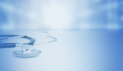 The stethoscope is lying on the table in the medical room. copy space.