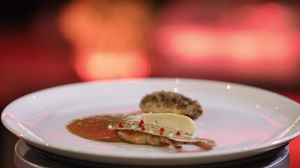 A beautifully plated gourmet dish featuring tender protein, rich sauce, creamy puree, and artistic garnishes. This elegant culinary creation is perfect for fine dining establishments