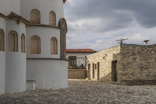 View of sun-kissed stone buildings and whitewashed walls meet under a dramatic sky in a timeless Cypriot village, Pano Lefkara, Larnaca, Cyprus.