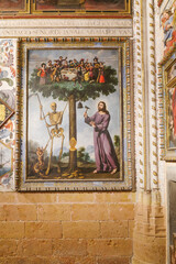 Segovia, Spain - 3 March, 2025: Allegorical painting of Jesus and a skeleton chopping down the Tree of Life, memento mori, Segovia Cathedral, Spain