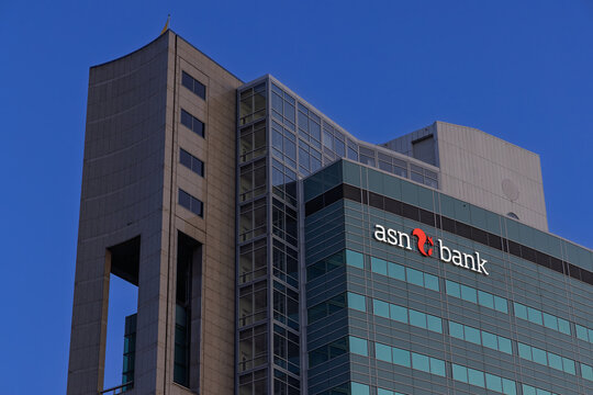 Modern architecture of the ASN Bank headquarters, a mix of glass and concrete under a bright blue sky. Utrecht, Netherlands. 11 July 2025.