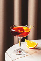 Classic revolver cocktail with bourbon and coffee liqueur at a stylish bar setting in the evening