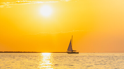 Sailing ship on Lake Constance before sunset, the sun illuminates the lake and conjures up intense...