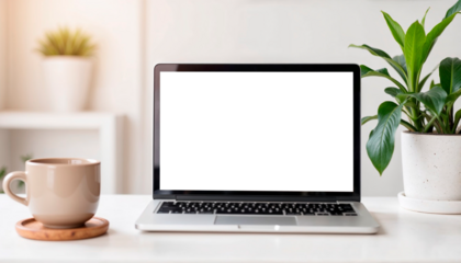 A modern desk setup featuring a laptop with a blank screen, a ceramic coffee cup on a wooden coaster, and green potted plants, creating a fresh and inviting workspace