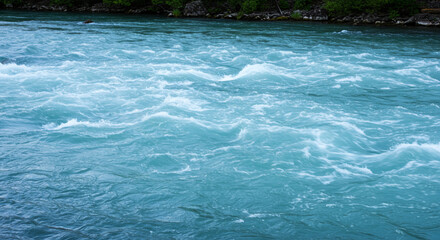 Close-up view of rapidly flowing turquoise water with white turbulent waves a natural phenomenon