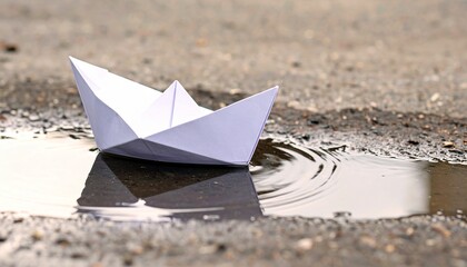 Obraz premium A paper boat floating on a puddle symbolizes knowledge and imagination, perfect for International Literacy Day. This conveys learning, education, and childhood dreams.