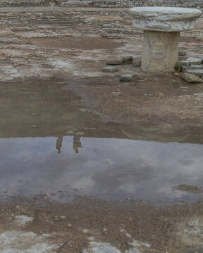 View of ancient ruins reflecting in a still pool, mirroring the sky above the weathered stones, evoking history's silence, Salamis Harabeleri, Harabeleri Salamis Yolu, Cipro.