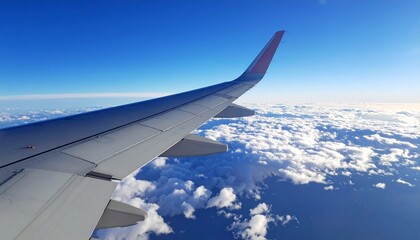 Obraz premium Airplane Wing Above Clouds Scenic Flight View and Serene Air Travel Journey
