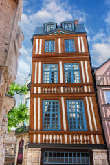 Historic half-timbered houses showcase architectural beauty in Rouen, France on a clear sunny day