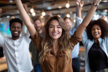 Fototapeta premium Group of young adults celebrating joyfully in a modern office environment