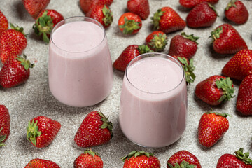 Freshly made sweet strawberry milkshake with milk, ice cream and strawberries.