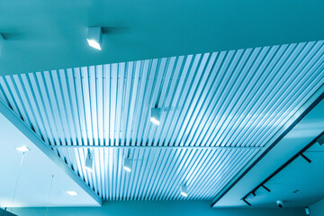 Ceiling with bright lights in a modern warehouse, shopping center building, office commercial real...