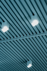 Ceiling with bright lights in a modern warehouse, shopping center building, office or commercial...