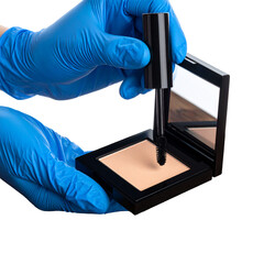 Hands in blue gloves applying makeup powder to compact