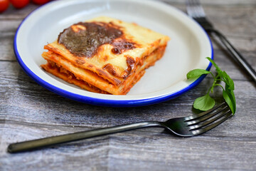   Delicious Home made Lasagna  with minced meat,tomato sauce and spinach  on a wooden rustic ...