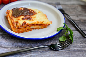   Delicious Home made Lasagna  with minced meat,tomato sauce and spinach  on a wooden rustic ...