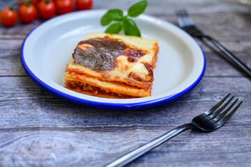   Delicious Home made Lasagna  with minced meat,tomato sauce and spinach  on a wooden rustic ...