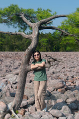 Naklejka premium A happy asian woman wearing sunglasses near a pine tree in Carbon county Pennsylvania.